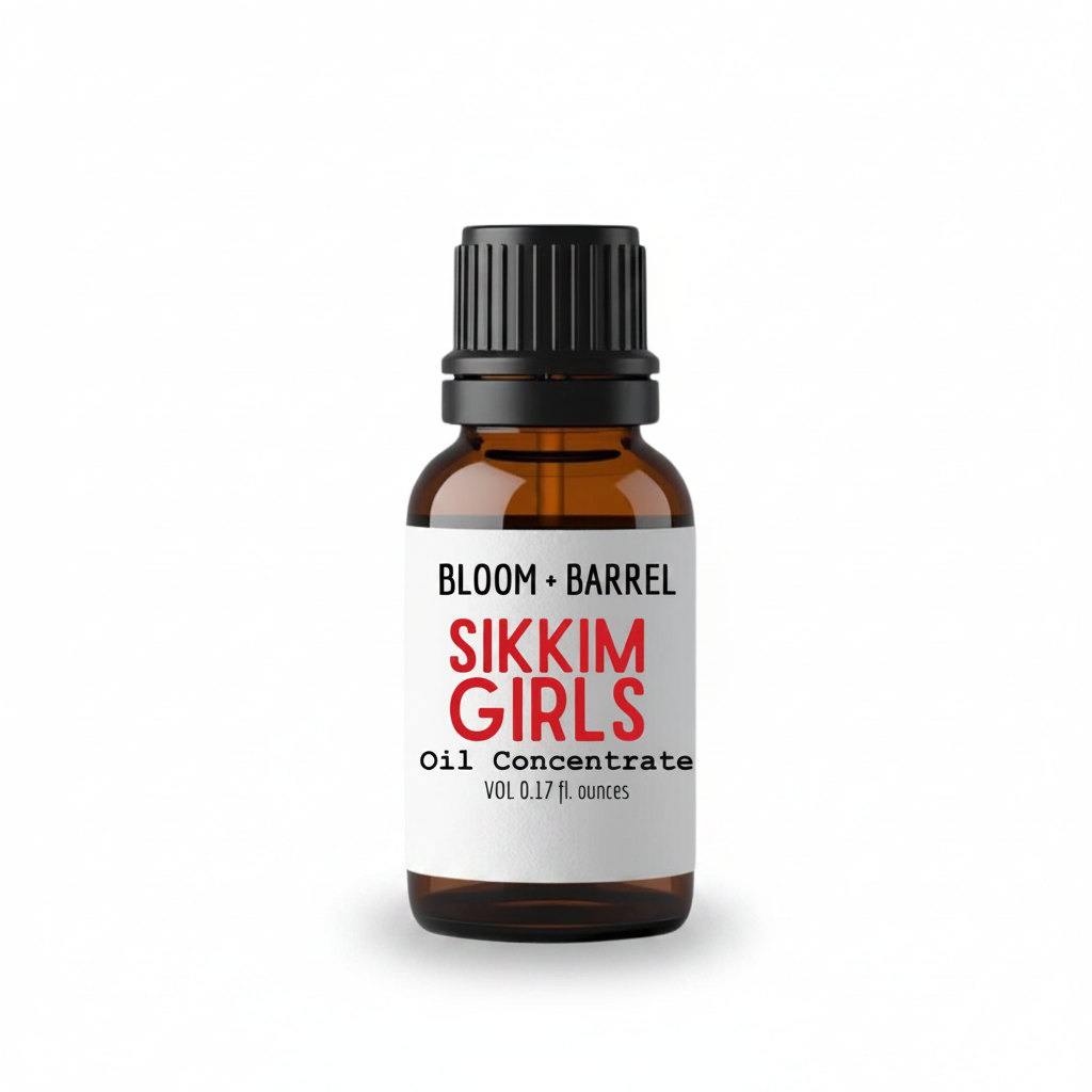 A small amber glass bottle with a black ribbed cap and a white label reading 'BLOOM + BARREL' and 'SIKKIM GIRLS Oil Concentrate' on a plain white background.