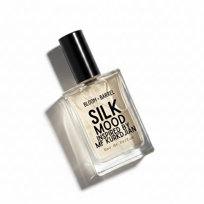 Bloom Barrel Silk Mood Eau de Parfum in a clear rectangular glass bottle with a black cap, on a white background.