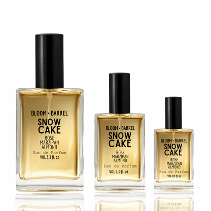 Three bottles of Bloom + Barrel Snow Cake perfume on a white background