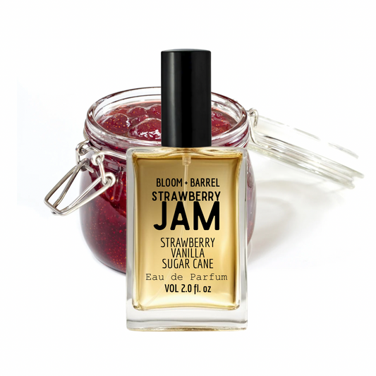 Perfume bottle labeled 'Strawberry Jam' with a jar of strawberry jam in the background