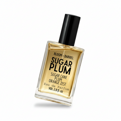 Bloom + Barrel Oreo Cookies Eau de Parfum in a clear rectangular glass bottle with a black cap, filled with golden-amber fragrance, on a white background.