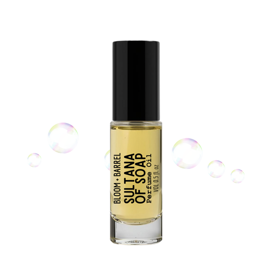Perfume bottle labeled 'Sultana of Soap' with soap bubbles on a white background