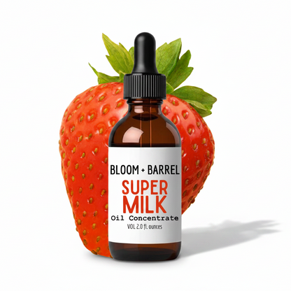 Bottle of Bloom + Barrel Super Milk Oil Concentrate with a strawberry on a white background