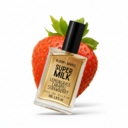 Perfume bottle labeled 'Super Milk Lemongrass Caramel Strawberry' on a strawberry-shaped stand.