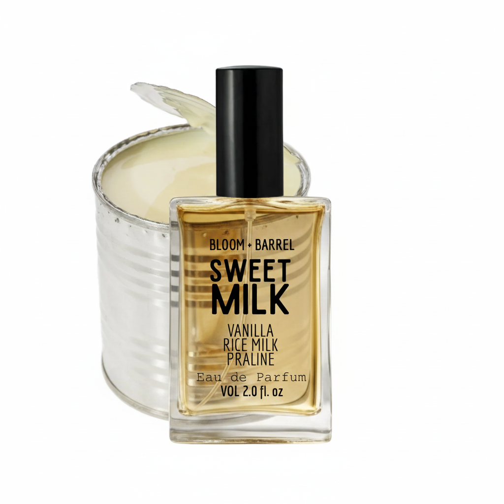 Bloom + Barrel Sweet Milk Eau de Parfum bottle in front of a silver tin candle with a wick, on a white background.