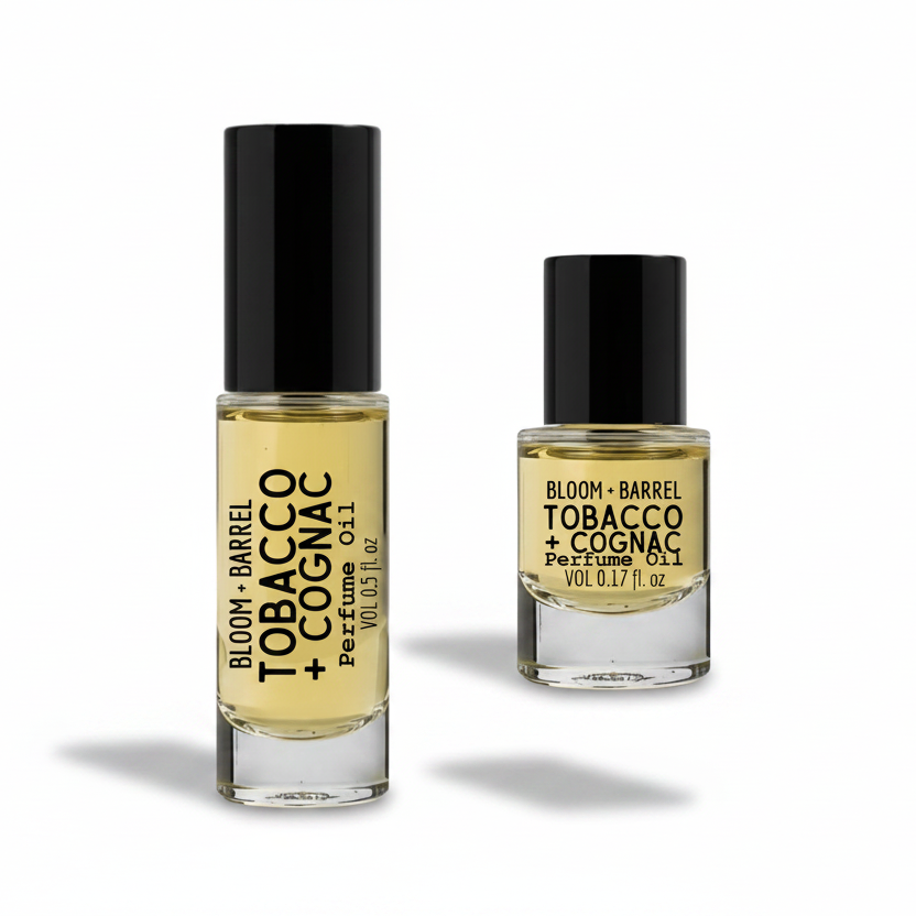 Two bottles of Bloom & Barrel Tobacco + Cognac perfume oil on a white background