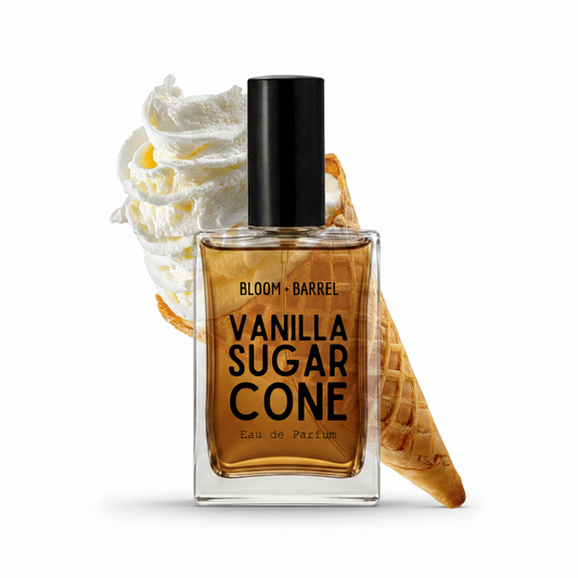 A rectangular glass perfume bottle labeled 'BLOOM • BARREL VANILLA SUGAR CONE Eau de Parfum' with a black cap, shown on a white background with whipped cream and a waffle cone behind it.