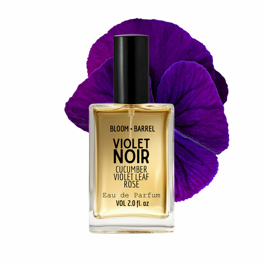 Perfume bottle labeled 'Violet Noir' with a purple flower on a white background