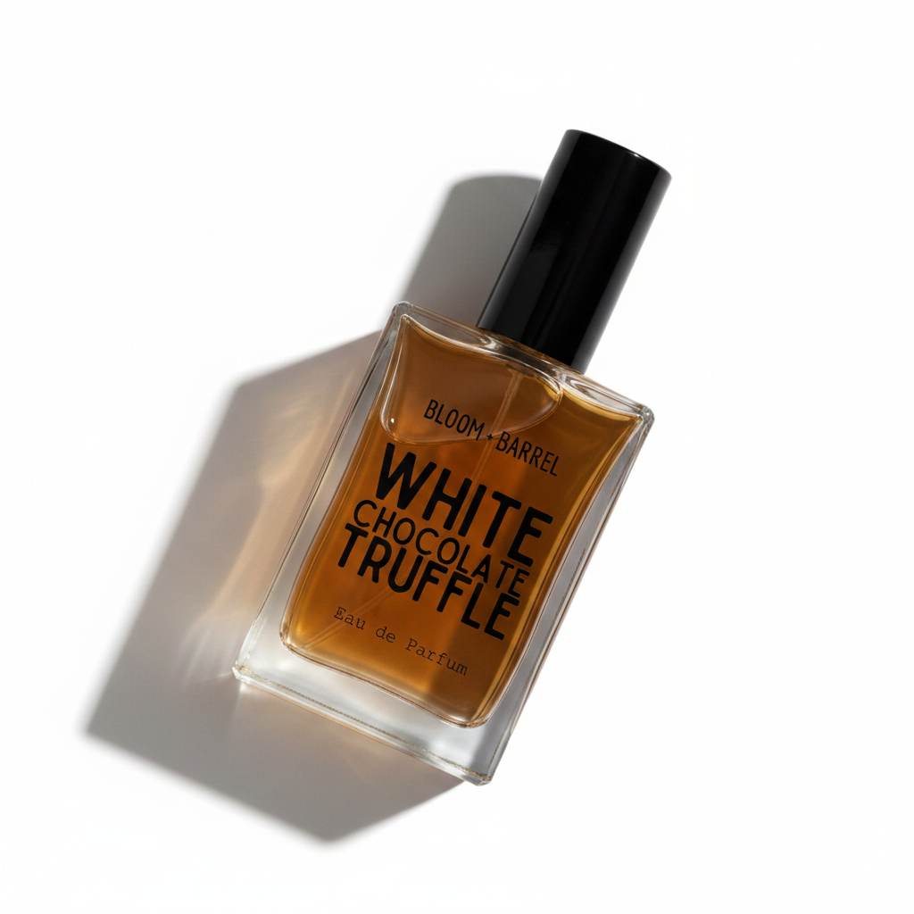 A rectangular glass perfume bottle filled with amber-brown liquid, featuring a black cylindrical cap and a clear label with bold black text reading 'BLOOM • BARREL' and 'WHITE CHOCOLATE TRUFFLE' on a plain white background.