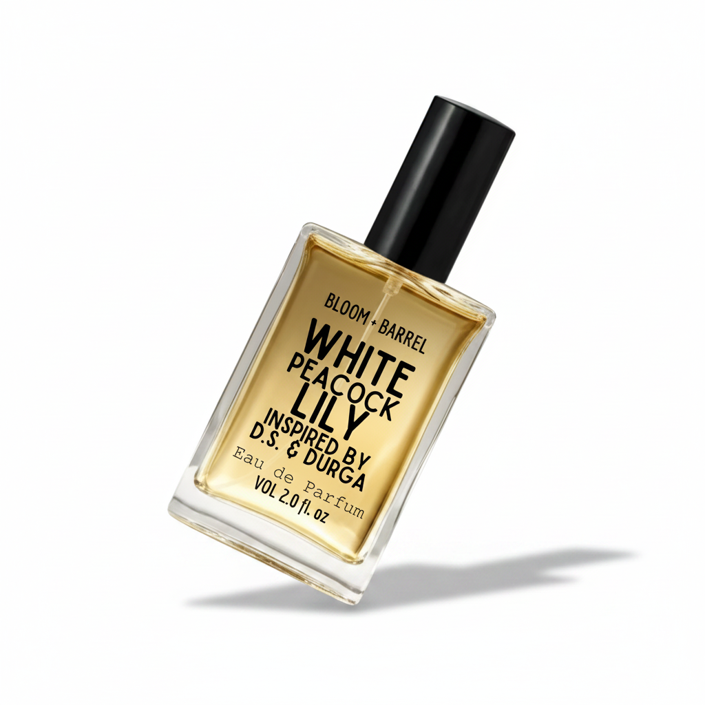 A rectangular glass perfume bottle with a black cap, filled with amber-colored fragrance liquid. The front label reads 'BLOOM + BARREL' and 'WHITE PEACOCK LILY